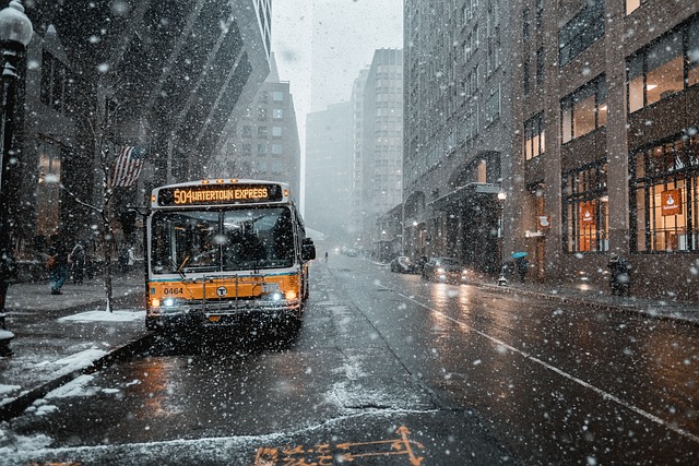 White West Road bus with city skyline behind